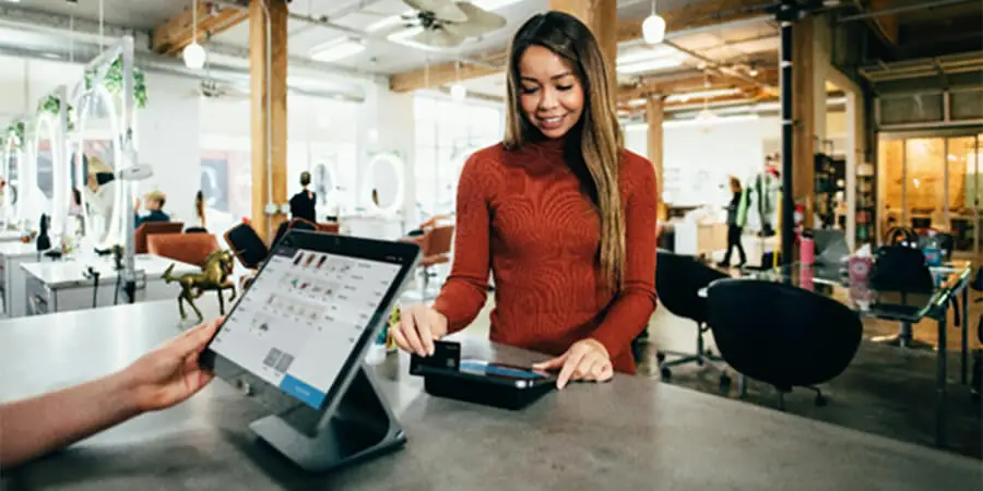 Happy customer paying for a product using a card.