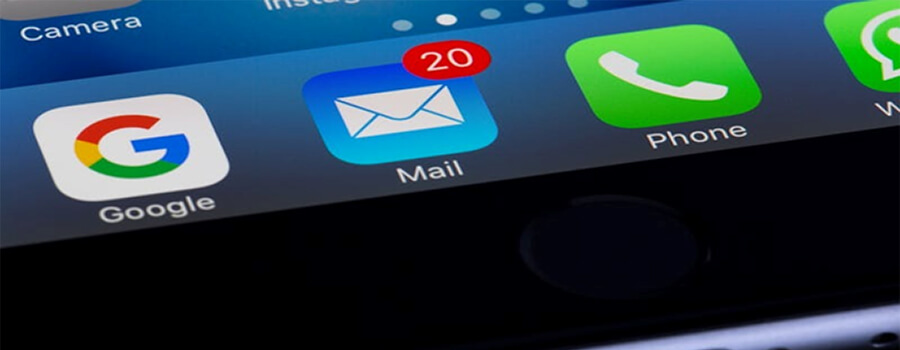 A close-up, angled view of a smartphone screen focusing on the blue Apple Mail app icon. A red notification badge on the icon indicates '20' unread messages. The Google app icon and green Phone app icon are visible on either side.