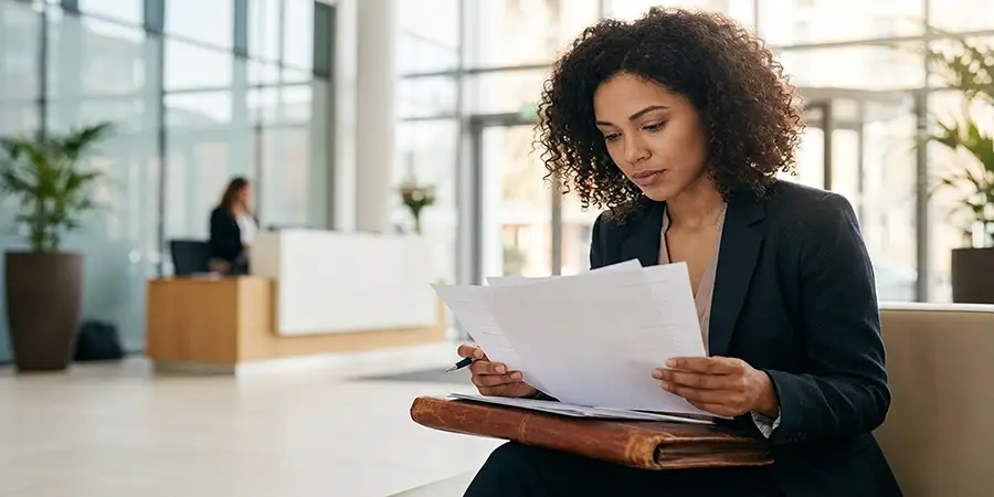 Focused candidate reviewing notes before a job interview