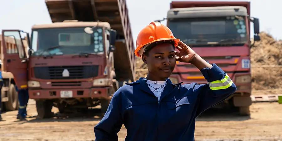 Frontline manager on a contruction site with two trucks.