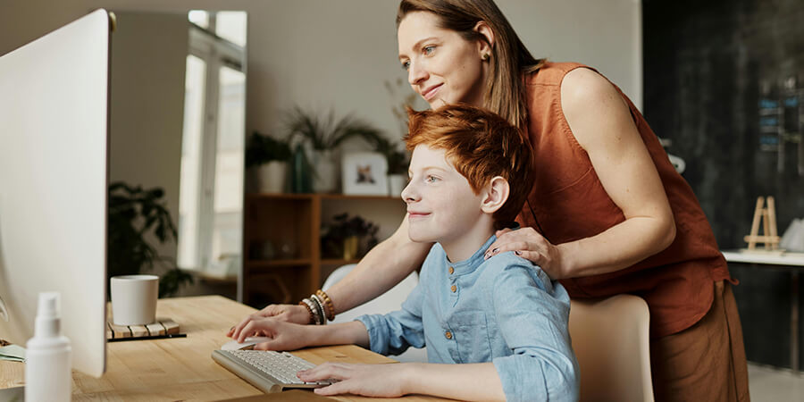 Mother and son using a computer to study.