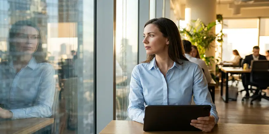 A professional taking a quiet moment of self-reflection to build self-awareness