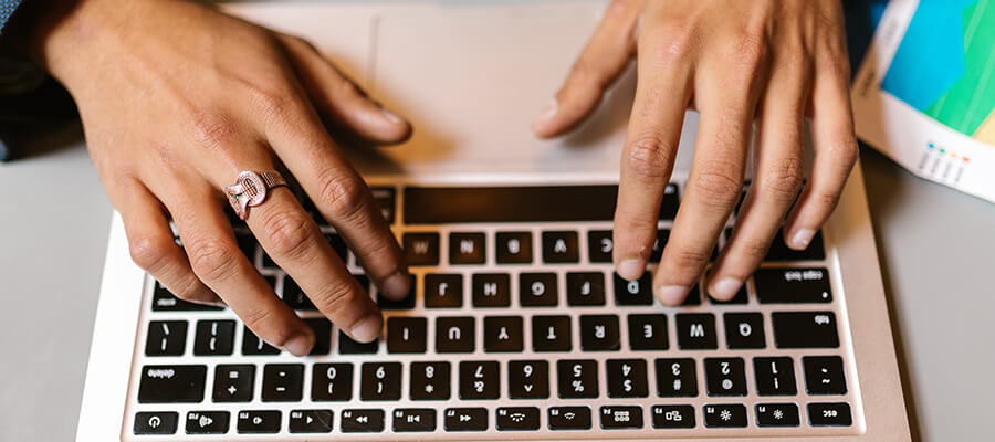 Typing on a laptop keyboard.