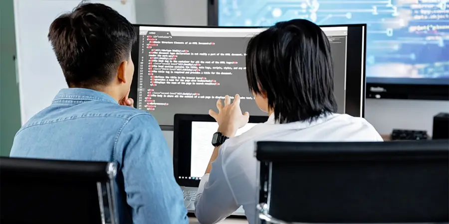 Professionals collaborating and learning a new digital tool together in a modern office